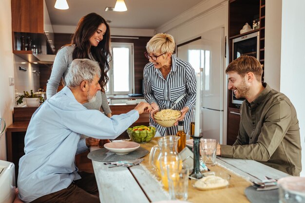 Lovely family enjoying weekend at home and having lunch together