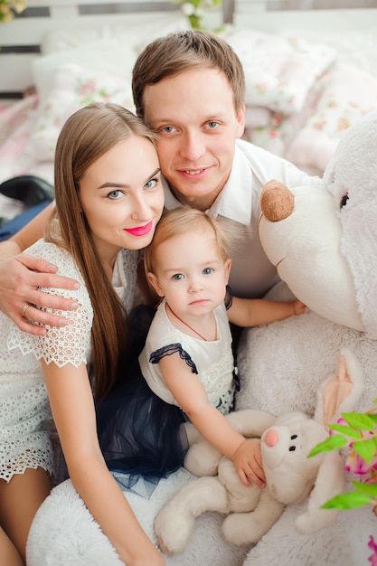 Lovely family smiling and laughing, posing at camera, and hugging each other