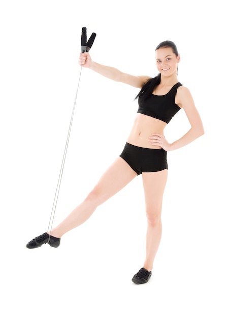 Photo lovely fitness instructor with jump rope over white