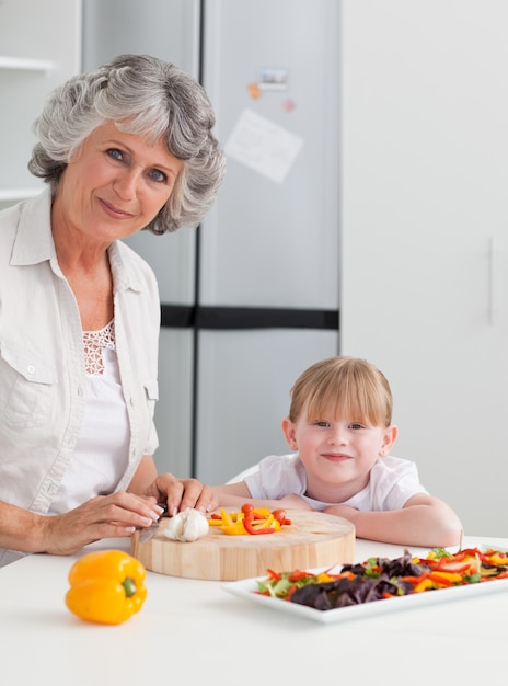 Lovely girl and her grandmother looking at the camera