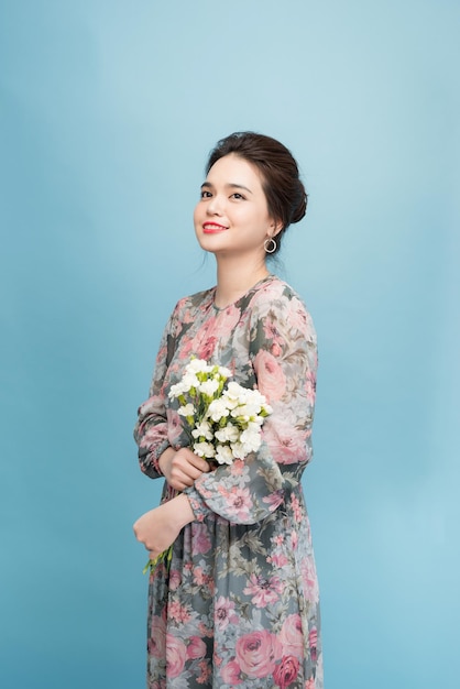 Lovely girl holds flowers bouquet