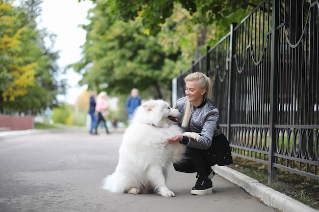 Lovely girl on a walk with a beautiful dog