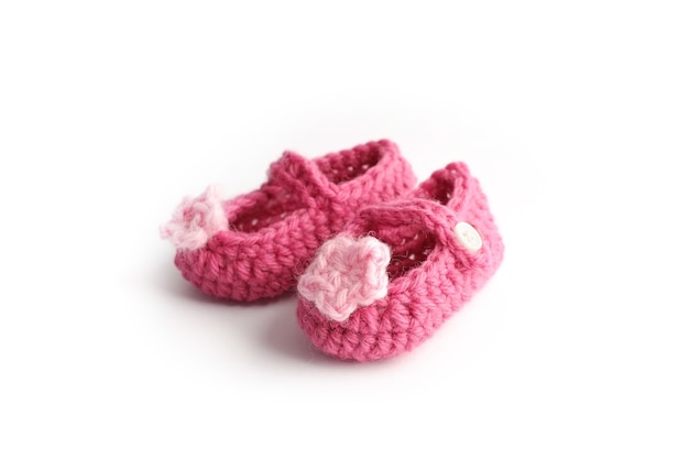 Lovely handmade cute baby red shoes with pink flower made by wool, isolated 