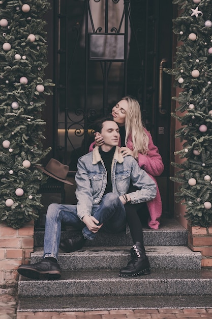 Lovely happy couple sitting in city streets