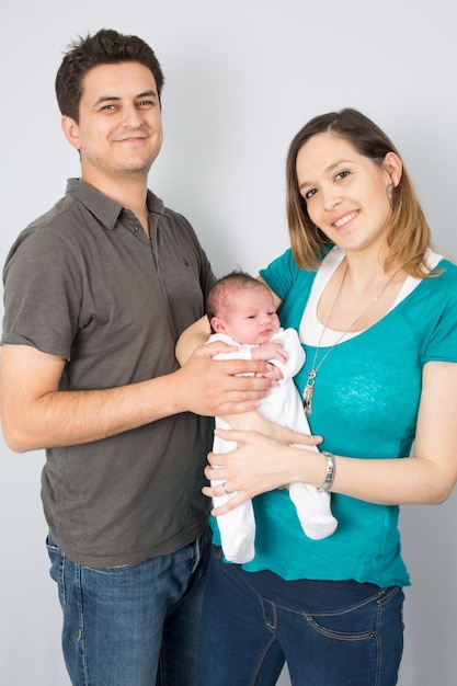 Lovely and happy family with their first  baby