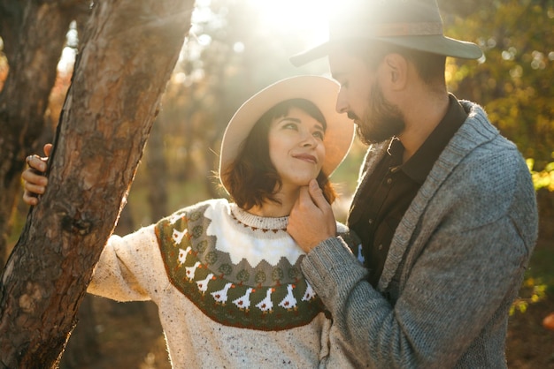 Lovely hipster couple looking at each other Couple wearing beautiful hats and sweaters