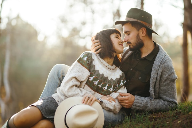 Lovely hipster couple looking at each other Couple wearing beautiful hats and sweaters