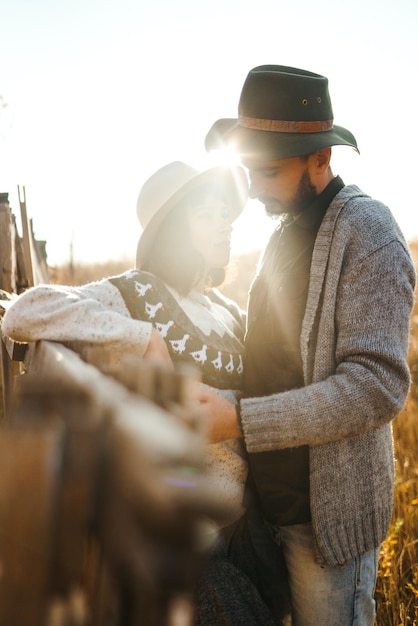 Lovely hipster couple looking at each other Couple wearing beautiful hats and sweaters