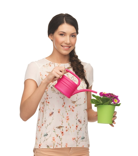 lovely housewife with flower in pot and watering can