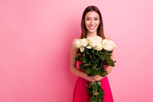 Lovely lady posing with a bouquet of roses