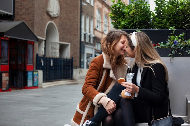 Lovely lesbian women kissing outdoors