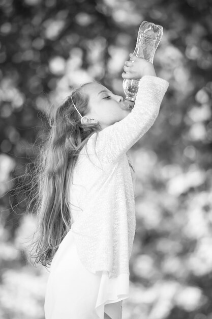 Lovely little girl drinking water