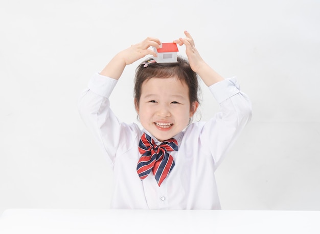 The lovely little girl has a small house in her hand