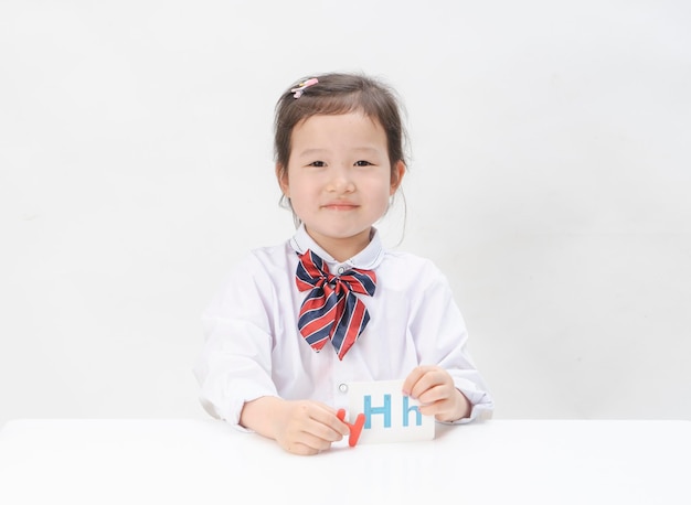 The lovely little girl is learning letters