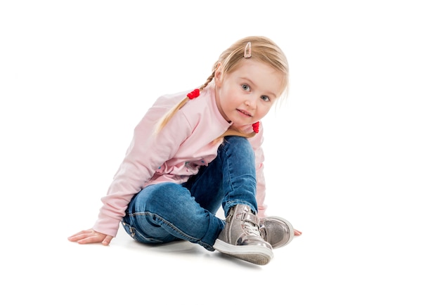 Lovely little girl sitting on the floor