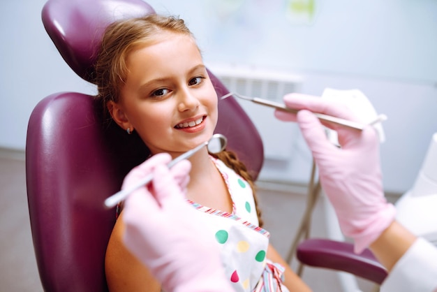 Lovely little girl smiling after doing examination in a pediatric stomatology Milk teeth care