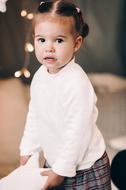 Lovely little girl with tails smiling at front