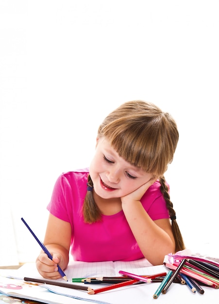 lovely little girl writing at the desk