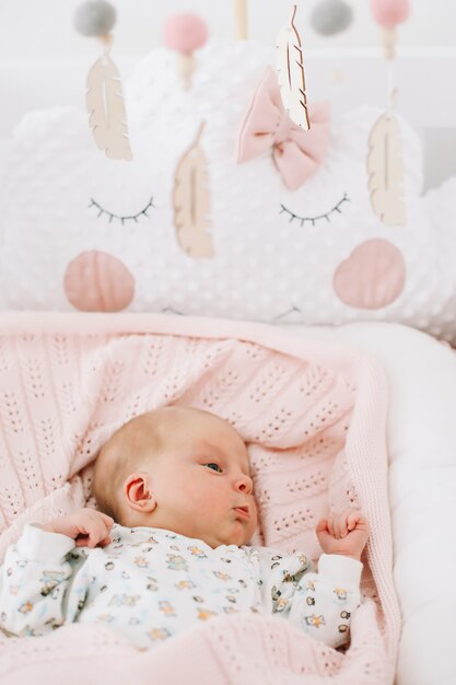 a lovely newborn baby girl in bed