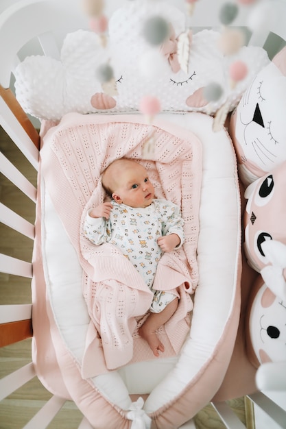 a lovely newborn baby girl in bed