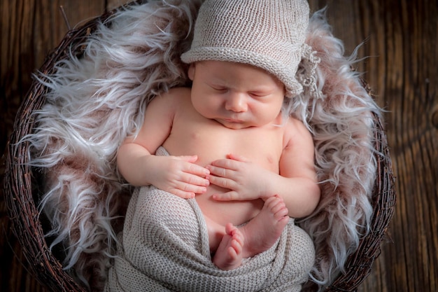 Lovely newborn baby sleeping on the blanket