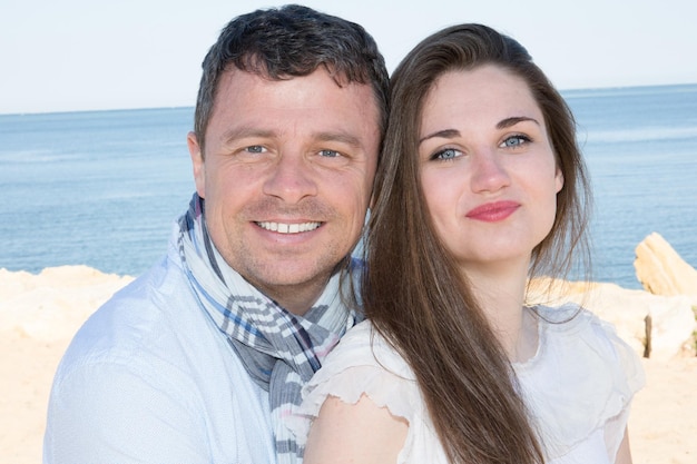 Lovely newly couple at the beach smiling