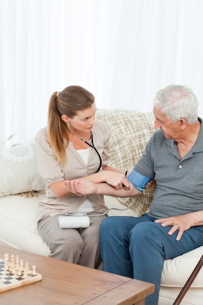 Lovely nurse helping her patient to do exercises