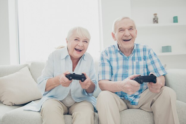 Lovely older couple posing together on the couch