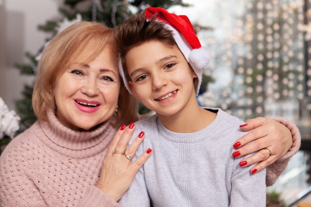 Lovely senior woman celebrating Christmas with her grandson