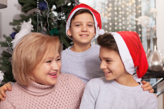 Lovely senior woman celebrating Christmas with her grandsons