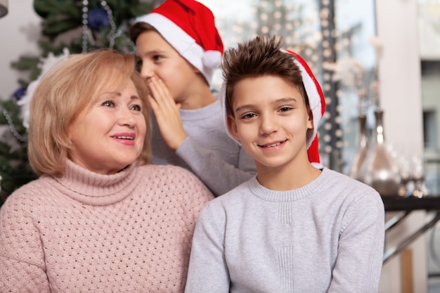 Lovely senior woman celebrating Christmas with her grandsons