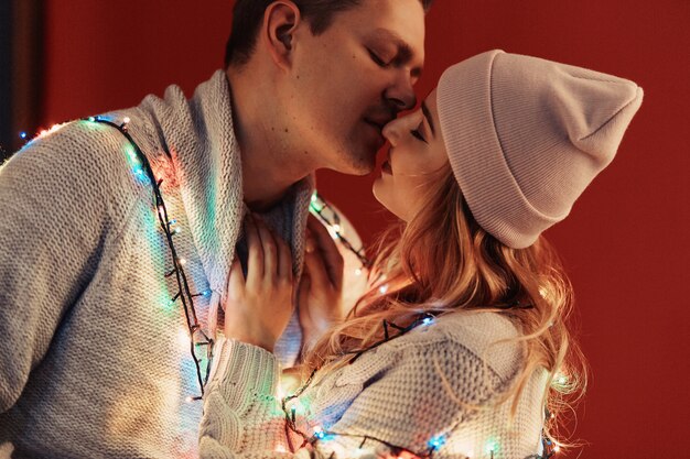 Lovely smiles, hugging couple portrait with lights