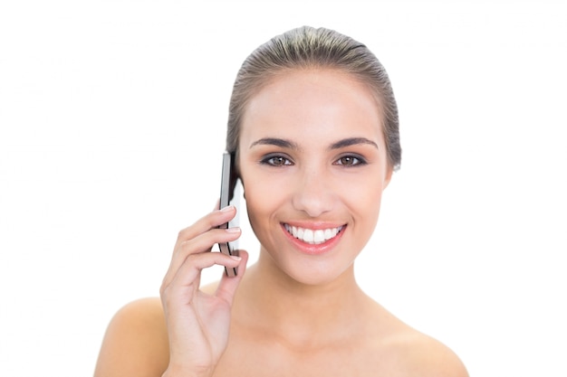 Lovely smiling brunette woman using a mobile phone