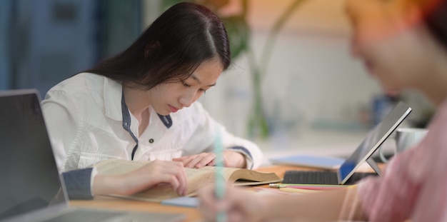 Lovely teenager girl reading books