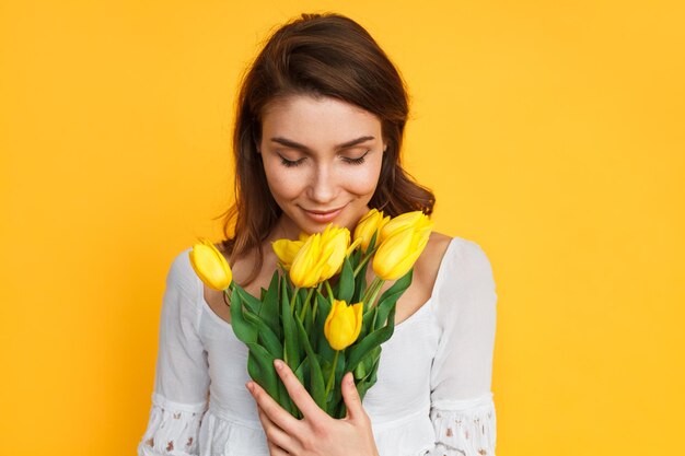 Lovely woman enjoying flowers