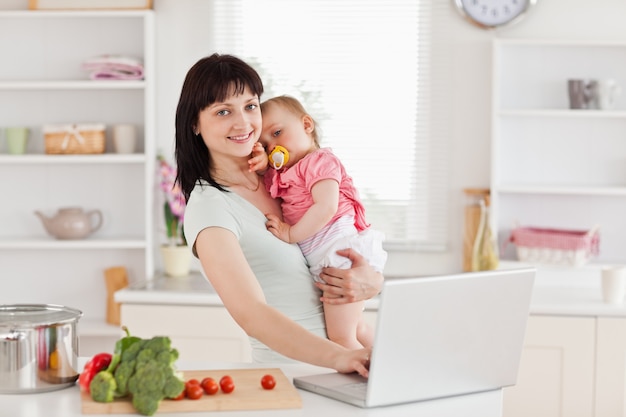 Lovely woman holding her baby in her arms