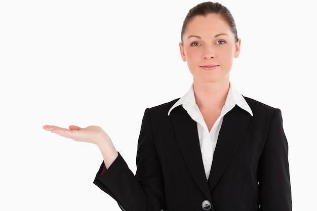 Lovely woman in suit showing a copy space while standing