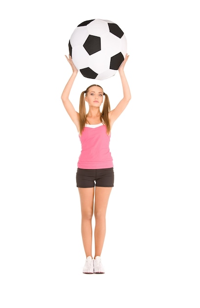 Photo lovely woman with big soccer ball over white wall