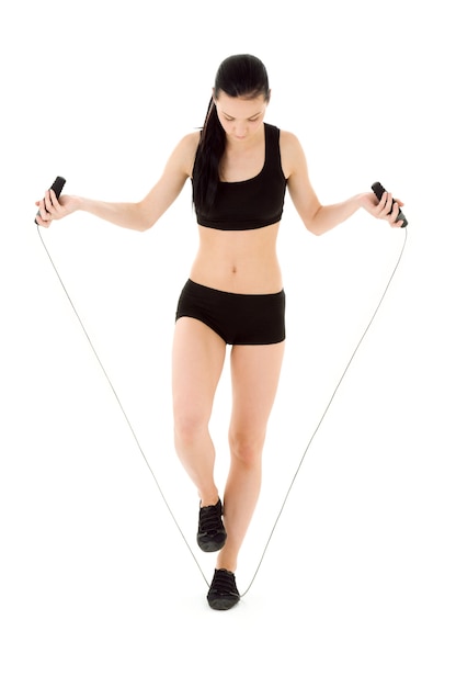 lovely woman with jump rope over white