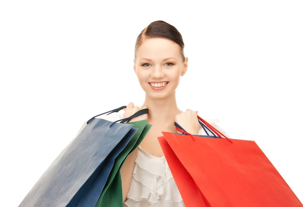 lovely woman with shopping bags over white