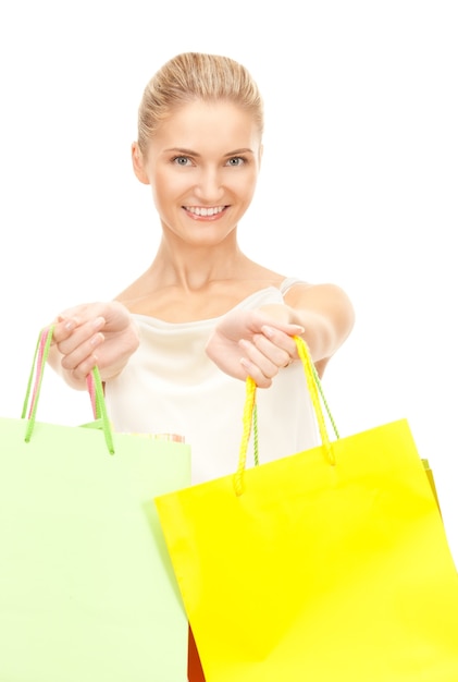 lovely woman with shopping bags over white