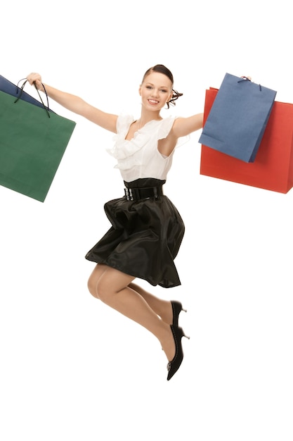 lovely woman with shopping bags over white