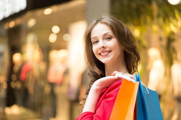 lovely woman with shopping bags over white