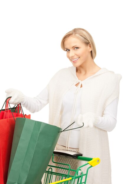 lovely woman with shopping cart over white