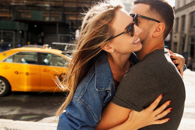 Lovely young couple dressed in casual style walks around Soho and New York city in morning lights 