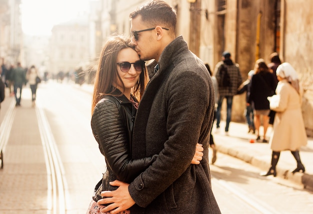 Lovely young couple hugging at the street