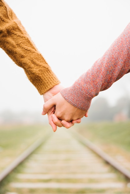 Photo lovely young couple standing holding hands