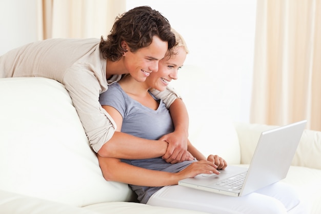 Lovely young couple using a notebook