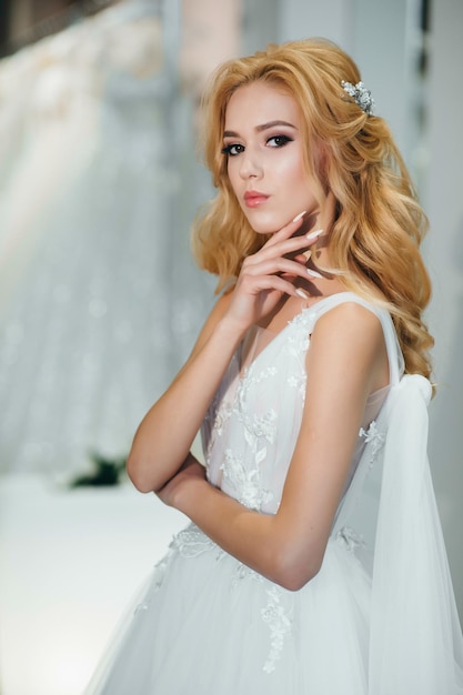 Lovely young woman bride in a lavish wedding dress