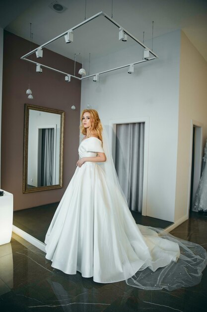 Lovely young woman bride in a lavish wedding dress